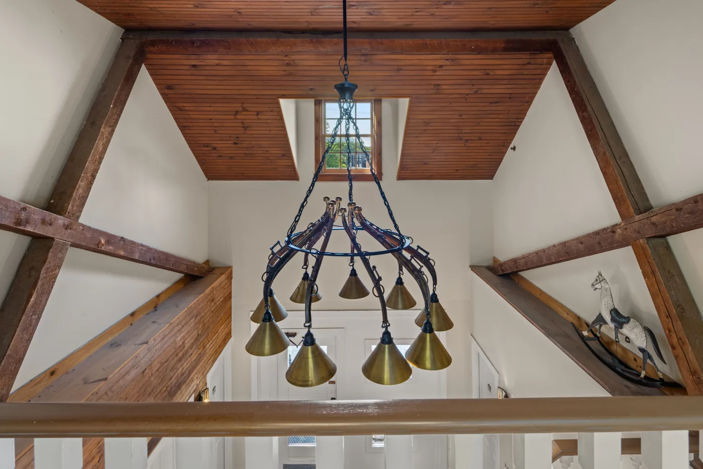 Custom horse-hames chandelier by Conant Metal & Light in the Carriage House foyer