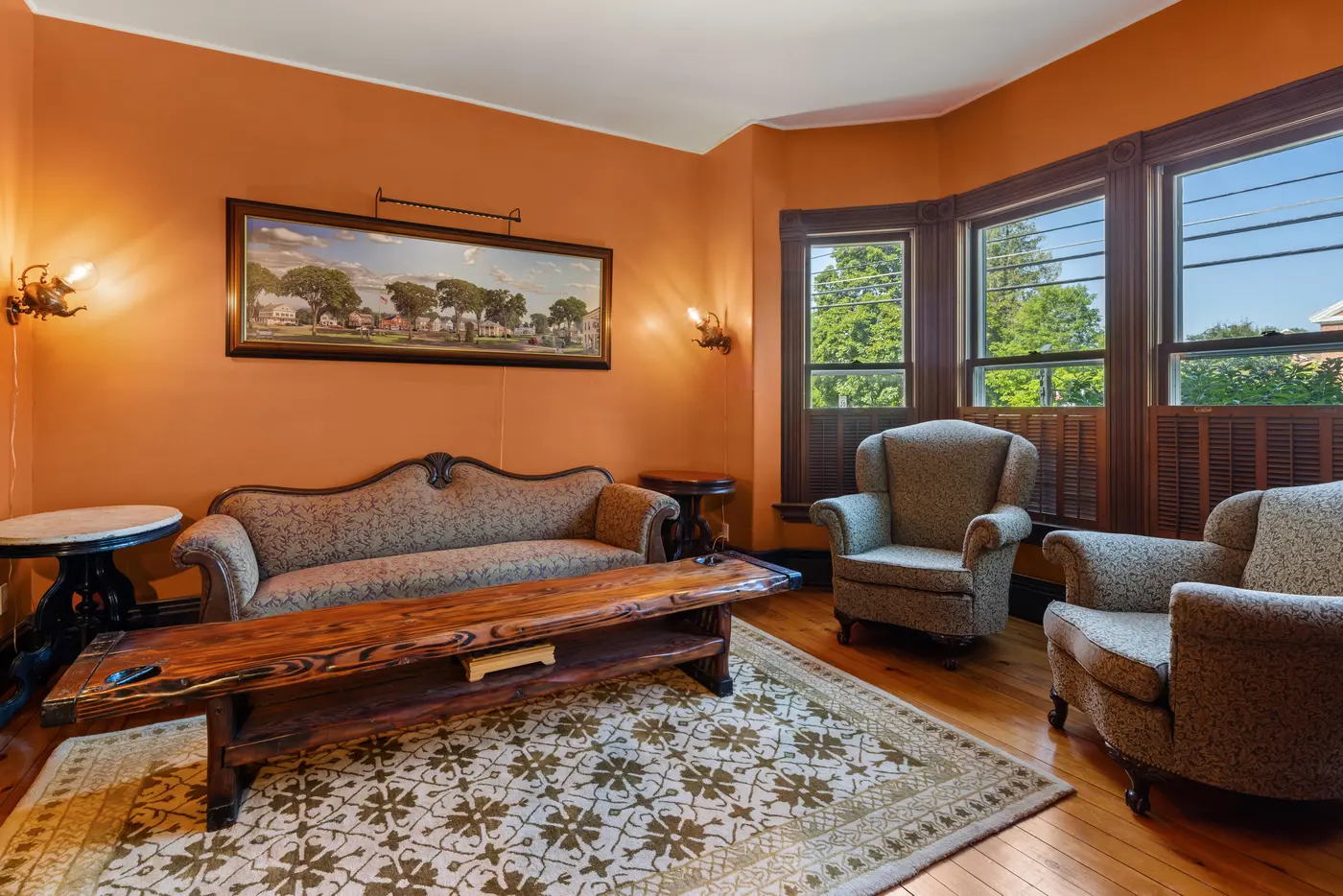 Main House sitting room with Victorian-era furnishings and stained-glass windows